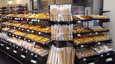 Shelves of Freshly Baked Bread Products Surrounding In-store Bakery