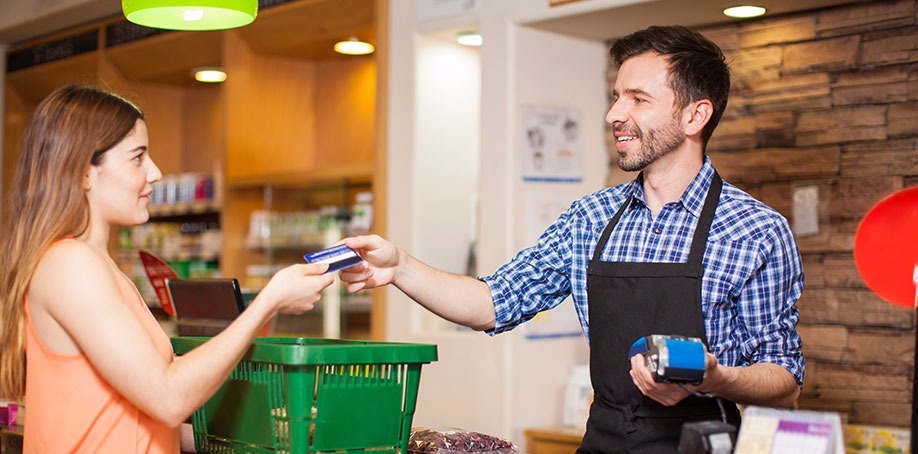 Customer paying for her purchase at the counter with the cashier