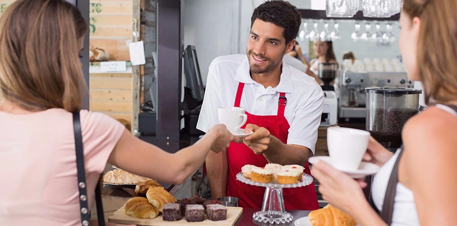 Barista serving coffee in a coffee shop